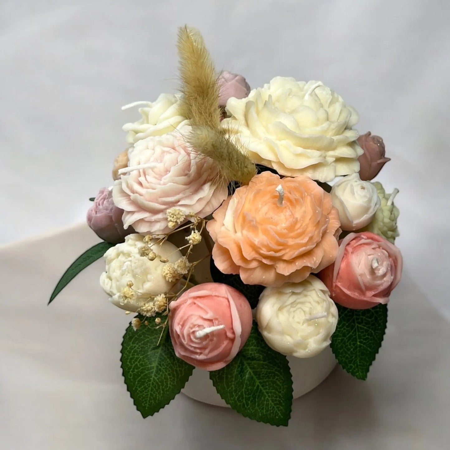 Beautifully designed candle bouquet in a charming decorative pot.