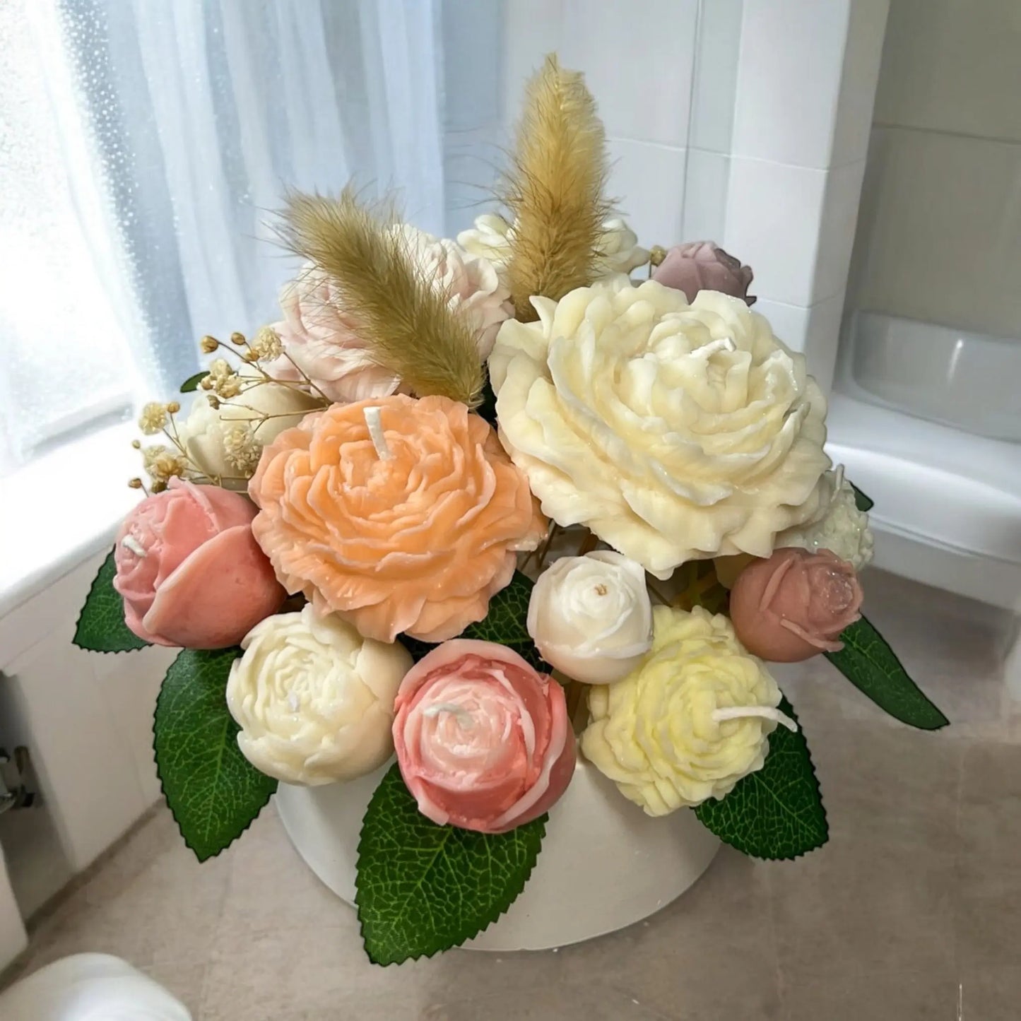 Elegant floral-inspired candle bouquet in a stylish pot.
