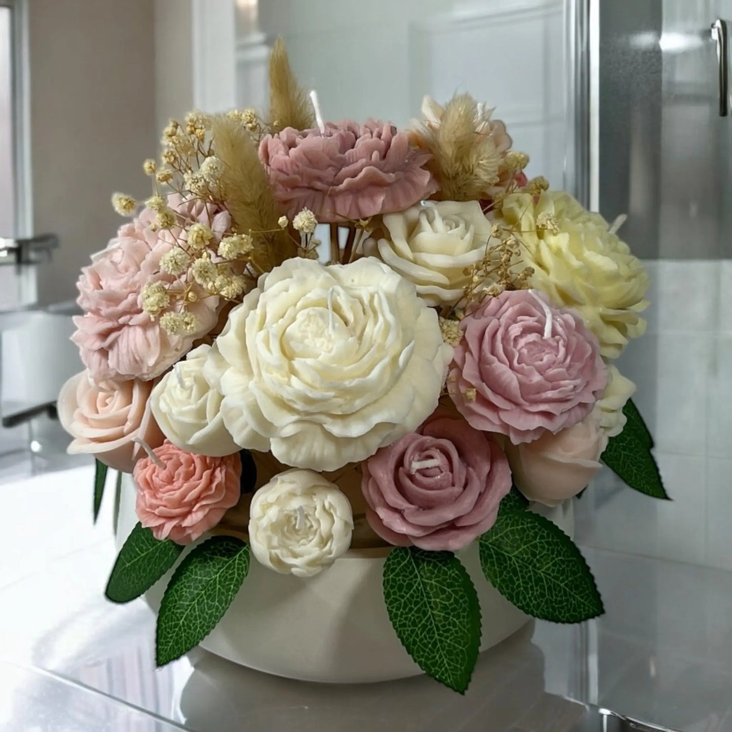 Handcrafted candle flowers in a beautifully textured decorative pot.