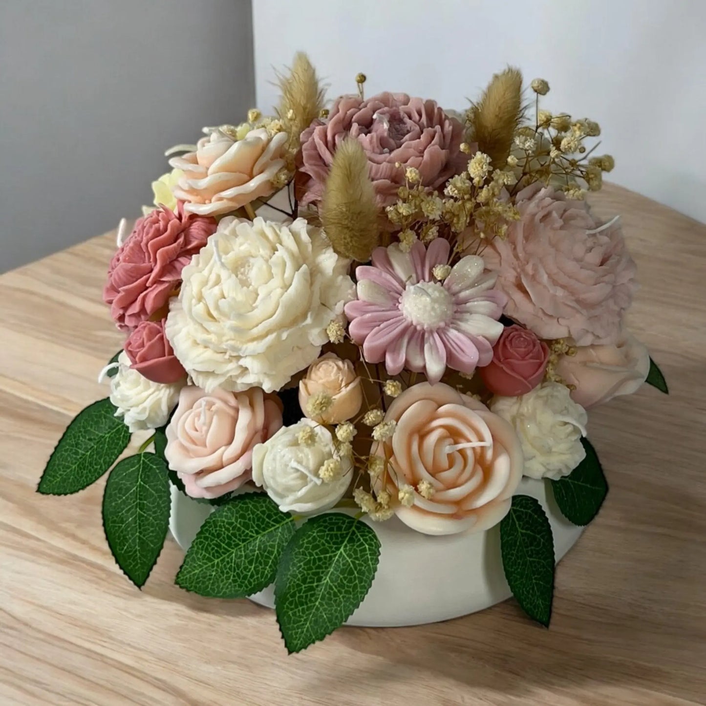 An elegant candle bouquet arrangement in a stylish home décor pot.
