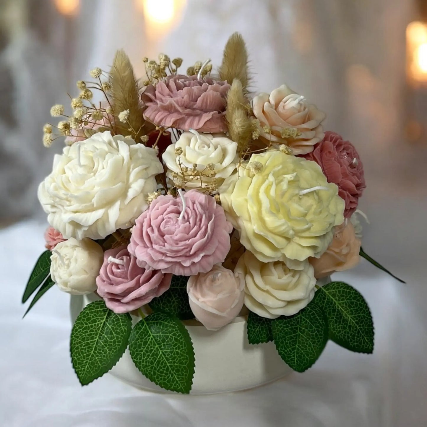 Luxurious floral candle bouquet in a decorative home pot.