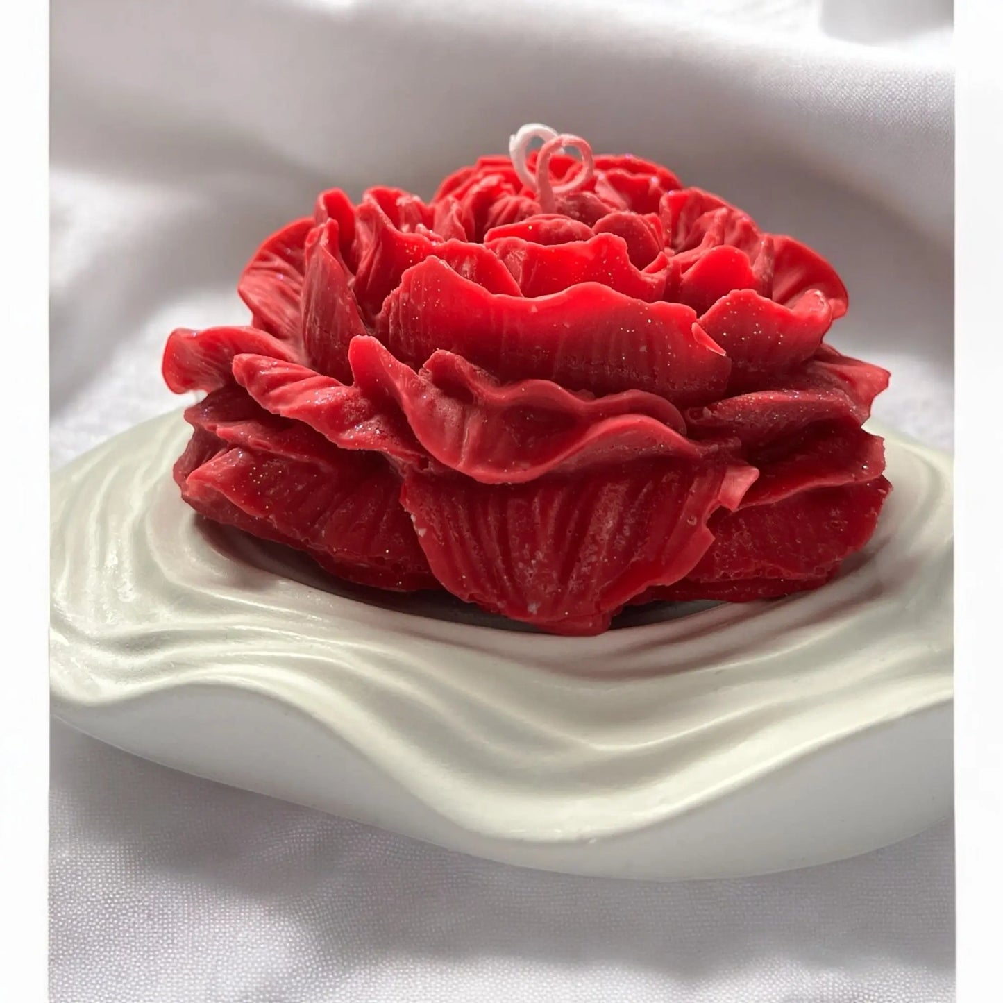 Luxurious red rose candle for a cozy ambiance.