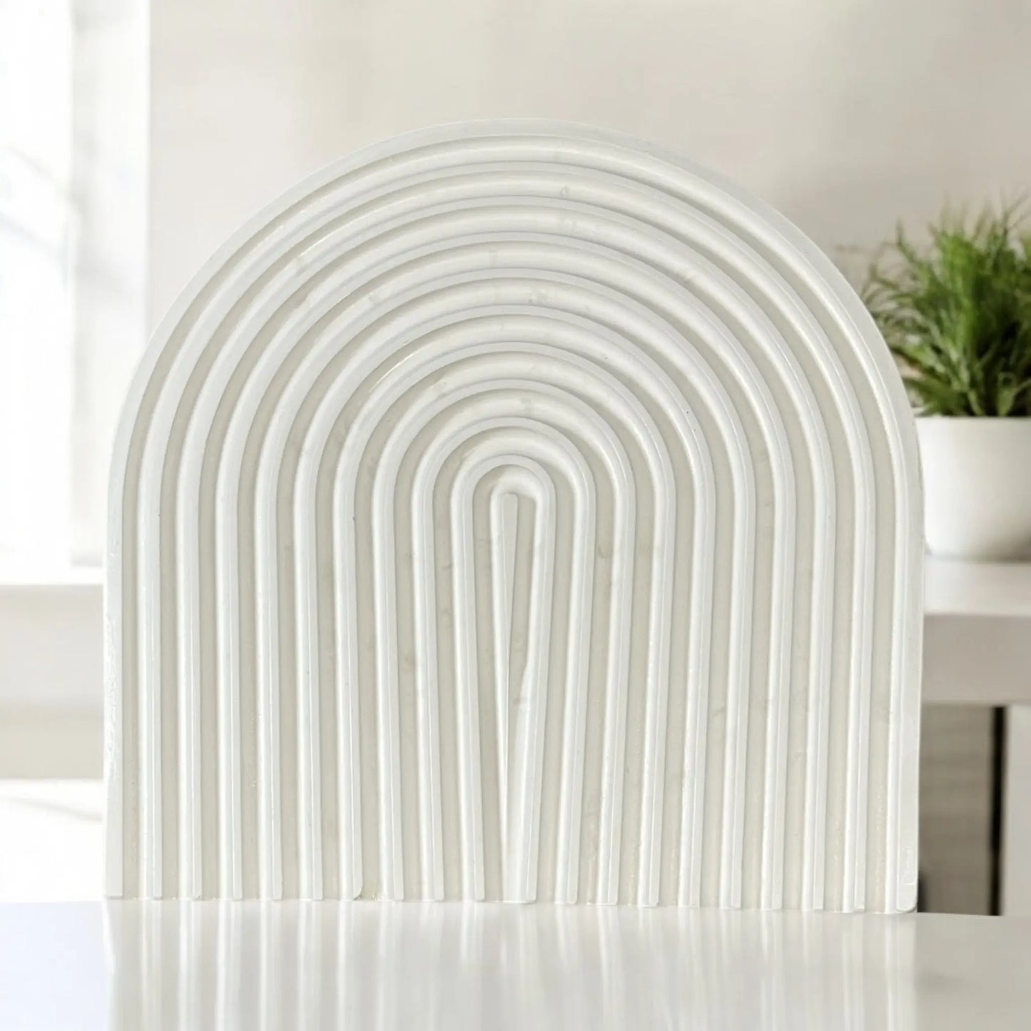 Functional and stylish arched tray for organizing accessories.