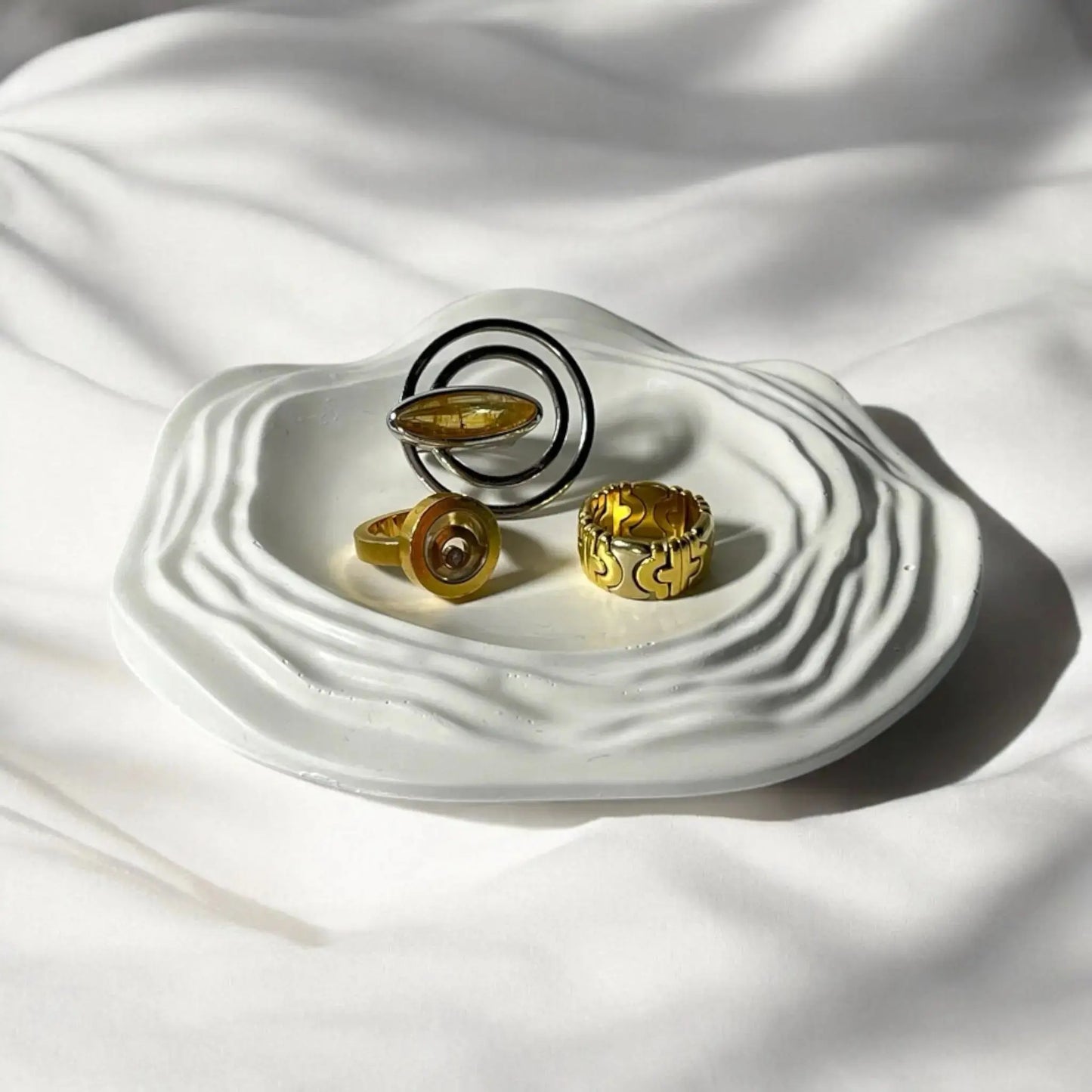 Modern wave tray for stylish candle and decor arrangement.