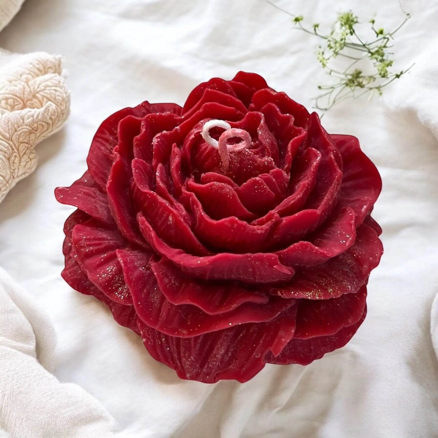 Elegant red rose-shaped candle for romantic decor.
