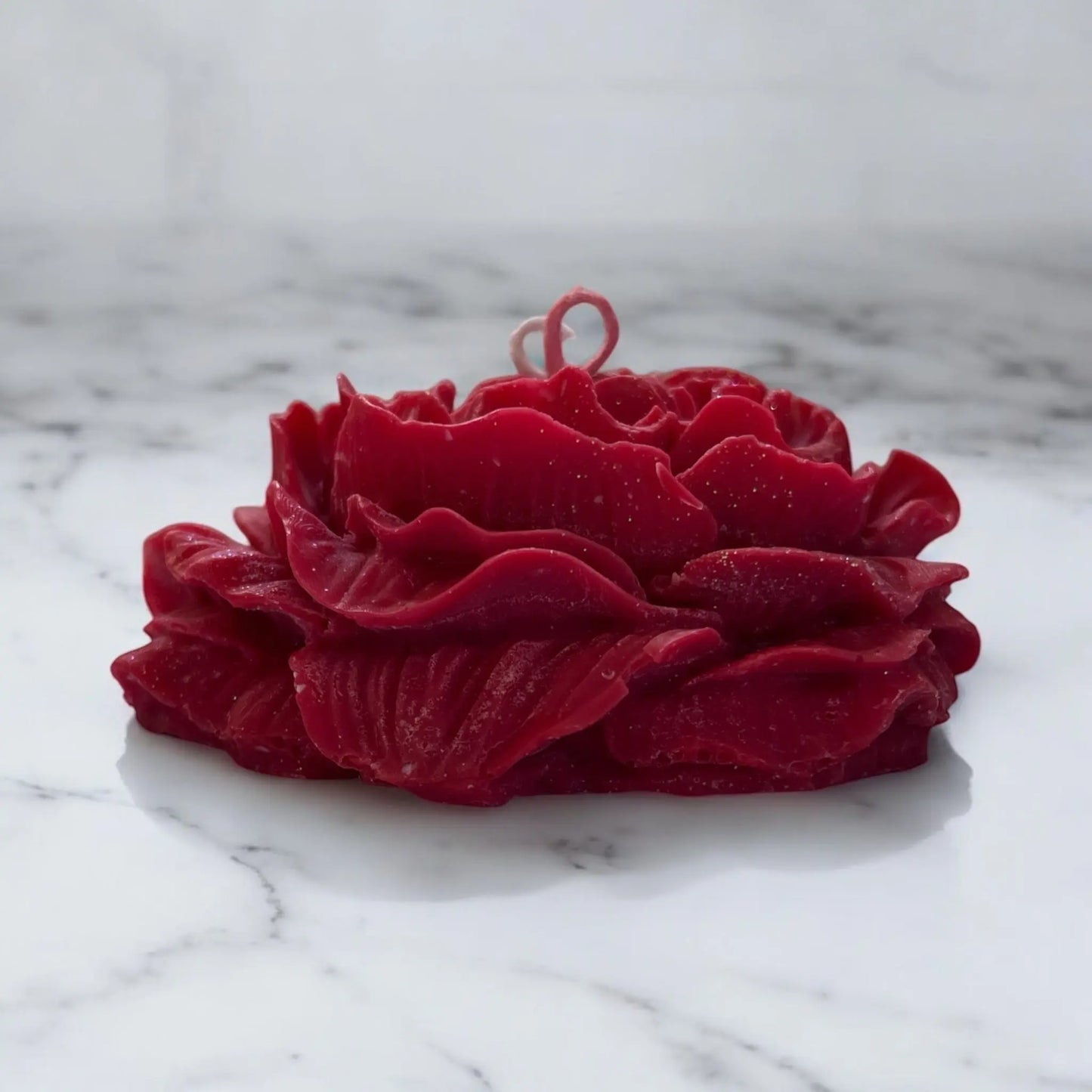 Handcrafted solo candle in the shape of a blooming rose.