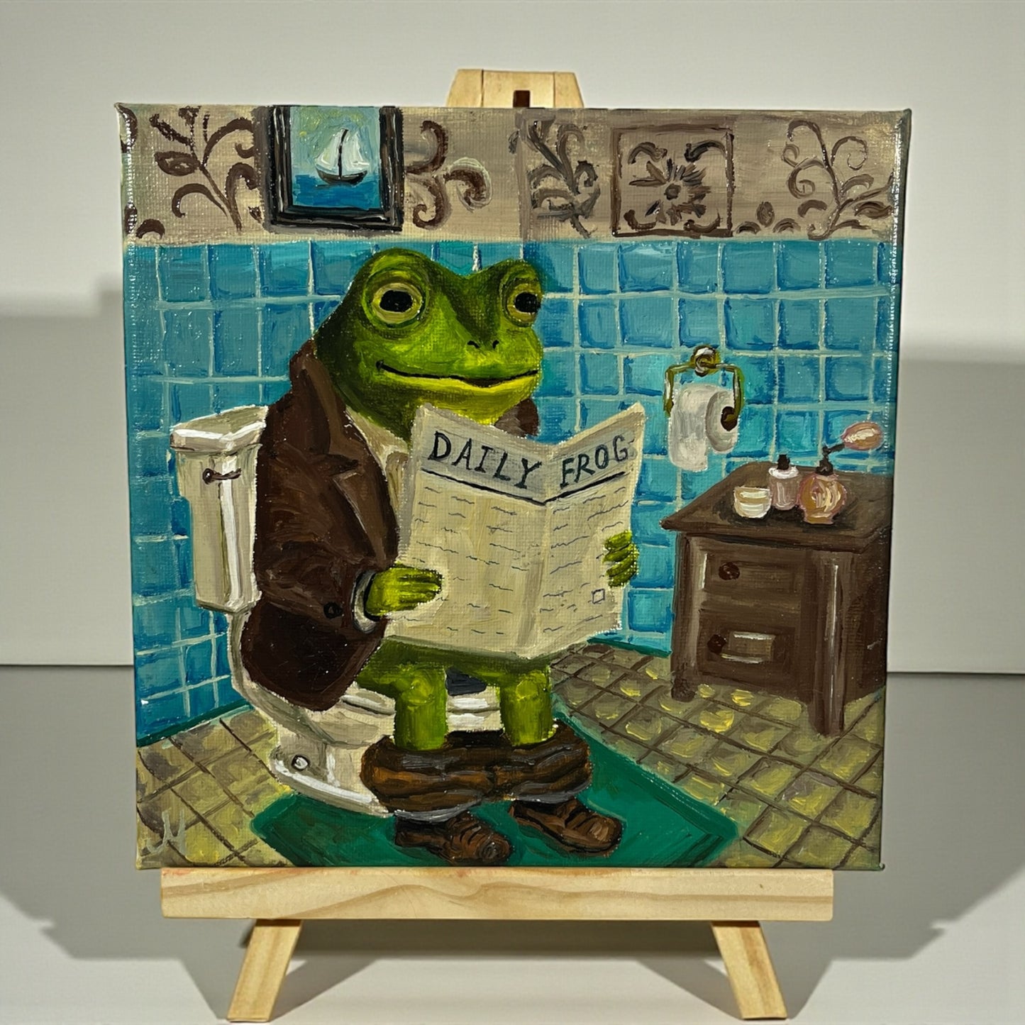 Alkuperäinen öljymaalaus sammakosta lukemassa sanomalehteä kylpyhuoneessa, Froggies-sarja
