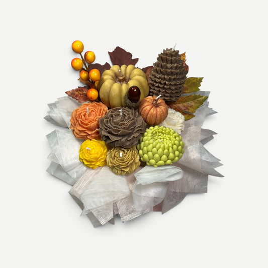 Fall-themed candle bouquet with pinecones and acorns