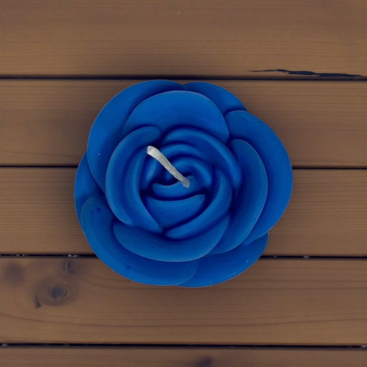 Carved wax candle in the form of a blooming rose.