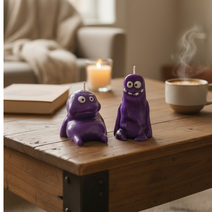 Flow-Flo purple soy wax "Cute Monster" character candles, handmade with unique features, perfect for decor or gifts.