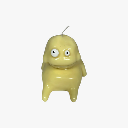 Flow-Flo Söpö Monsteri yellow soy wax character candle with googly eyes and a wide smile. Handmade decorative candle.